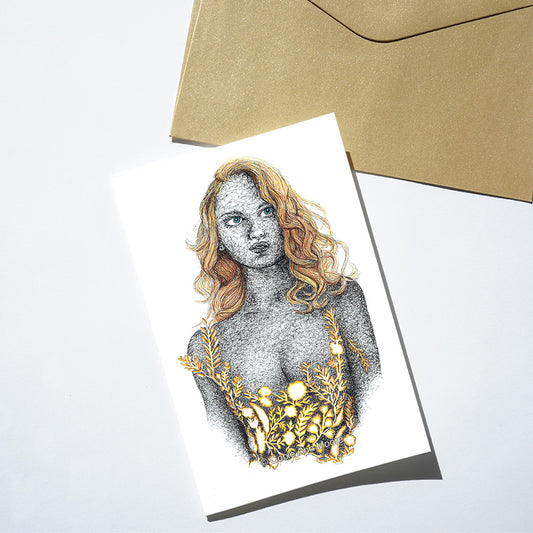 Greeting card with artistic illustration of a woman's face and gold leaves.